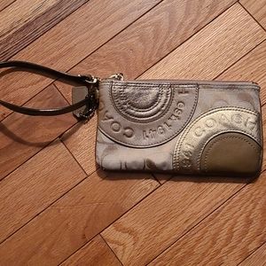 Gold colored coach wristlet